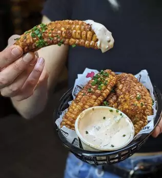 Hand holding fried corn